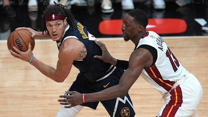 Denver Nuggets forward Aaron Gordon controls the ball while defended by Miami Heat center Bam Adebayo.